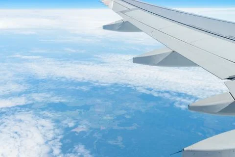 View from the window of the plane on the blue sky, in good weather. Фото