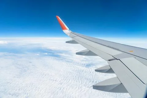 View from the window of the plane on the blue sky, in good weather. Фото