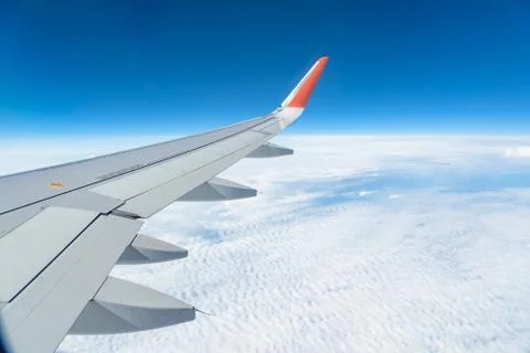 View from the window of the plane on the blue sky, in good weather. Fotos de archivo