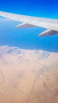 View from the window of plane on blue sky and earth with landscape of desert Stock Photos