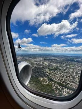 View from the window of the plane to the city. Stock Photos