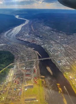 View from the window of the plane to the city of Ust-Kut on the Lena River in Stock Photos