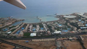View from the window of the plane on the Egyptian hotels on the coast Stock Footage 85707596