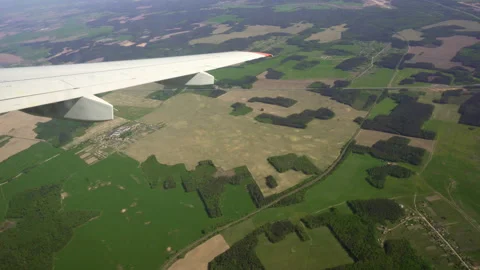 View from the window of the plane. Flight over the ground. Stock Footage 89779750