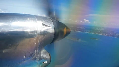 View from the window of plane flying over an island in ocean Stock Footage 130131128