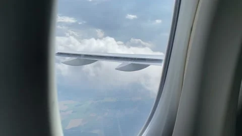 View from window of plane flying through clouds over France Stock Footage 161095384