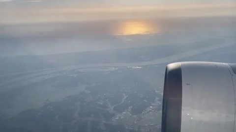 View from window plane with motor above crops at sunset Stock Footage 277289211