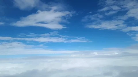 View from the window of the plane at the white clouds in the sky Vidéo 104510305