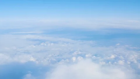 View from the window of the plane at the white clouds in the sky Video stock 125337259