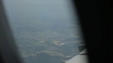 View from the window of the plane on the wing above the city. A passenger plane 스톡 사진