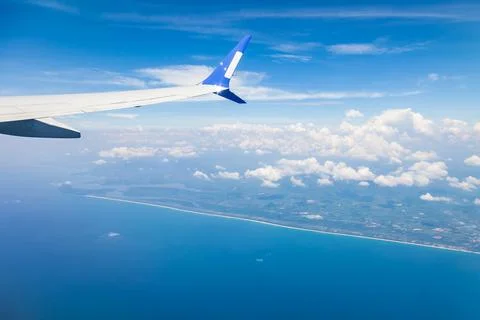 View from the window of the plane on the wing against the background of the.. Stock Photos