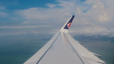 View from the window of the plane. Wing of an airplane flying above the clouds Stock Footage 100622898
