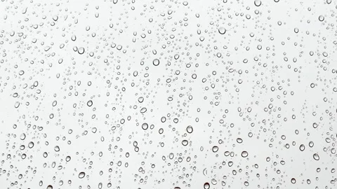 View from the window in rainy weather, raindrops on the window dripping down Stock Footage 304750691