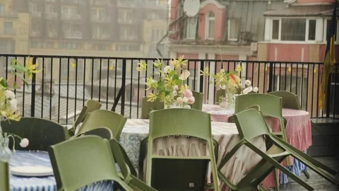 View from the window of a restaurant terrace during the rain. Empty wet tables Stock Footage 318066739