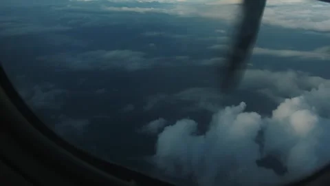 View from window of rotating propeller of an airplane flying above white fluffy Stock Footage 264843606