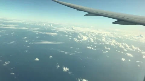 View from the window seat of a flight mid air Stock Footage 212636725