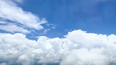View from the window seat of the plane in bright blue sky Stock Footage 218340004