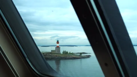 View from the window of the ship's deck to the sea islands and the lighthouse. Stock Footage 248531475