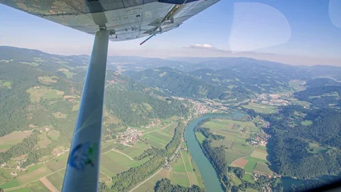 View from window of small airplane carrying a group of skydivers for a jump Stock Footage 129289993