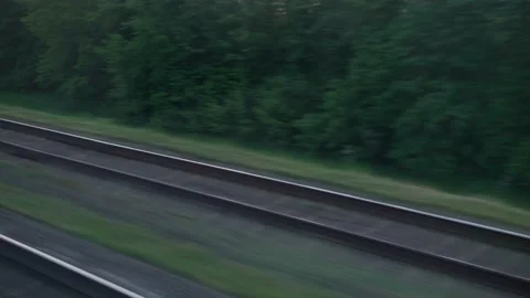 View from window of speed train with glare on glass and parallel rails on Stock Footage 156007684