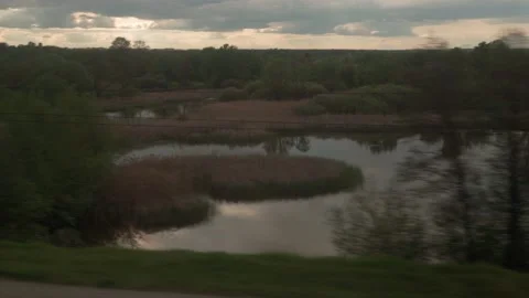 View from window of speed train with glare on glass on beautiful landscape of Stock Footage 156063973