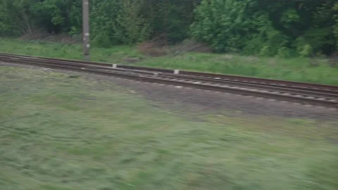 View from window of speed train with glare on glass and parallel rails on Stock Footage 156268845