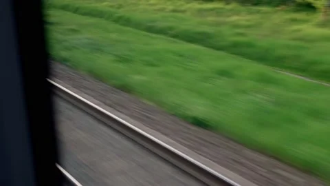 View from window of speed train with glare on glass and parallel rails on Stock Footage 156277751