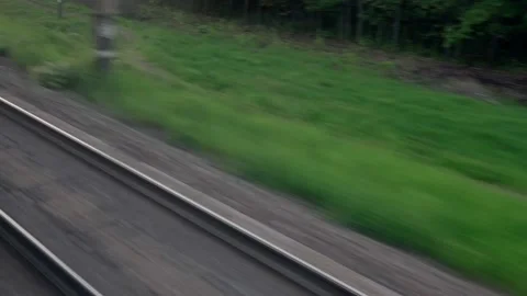 View from window of speed train with glare on glass and parallel rails on Stock Footage 156380624