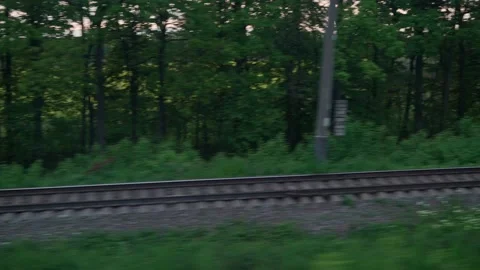 View from window of speed train with glare on glass and parallel rails on Stock Footage 156443057