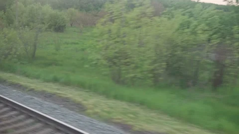View from window of speed train with glare on glass and parallel rails on Stock Footage 156494001