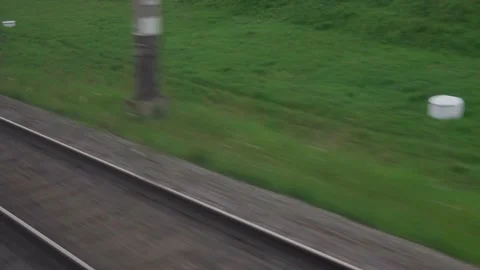 View from window of speed train with glare on glass and parallel rails on Stock-Footage 156872622