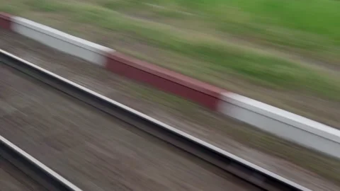 View from window of speed train with glare on glass and parallel rails on Stock Footage 157026121