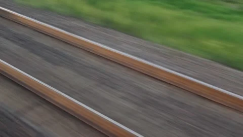 View from window of speed train with glare on glass and parallel rails on Stock Footage 157130526