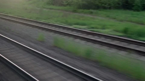 View from window of speed train with glare on glass and parallel rails on Stock Footage 157238589