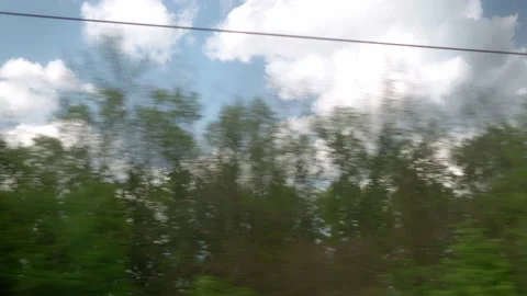 View from window of speed train with glare on glass on beautiful landscape of Video stock 157562976