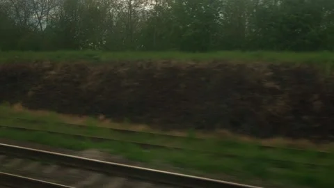 View from window of speed train with glare on glass and parallel rails on Stock Footage 197560869