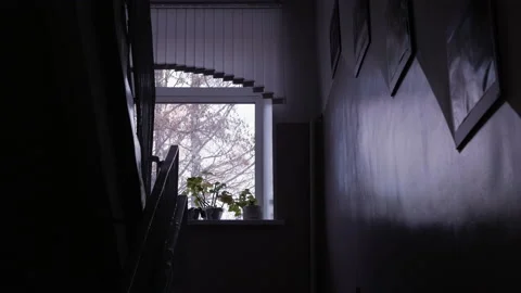 View of the window on the stairwell through which you can see the gray sky a Stock Footage 170486010