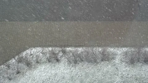 View from the window to the street from above. it is snowing with a blizzard.  Stock Footage 130791137