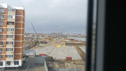 The view from the window is like on the street as a new multi-storey house is Stock Footage 233806065