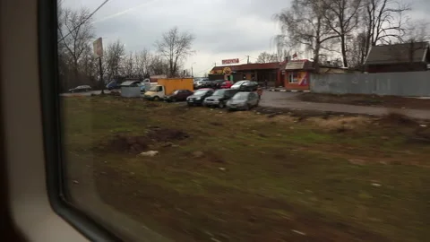 View from the window of a suburban train passing by stations and villages. Stock Footage 228636325