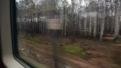 View from the window of a suburban train passing by stations and villages. Stock Footage 228636345