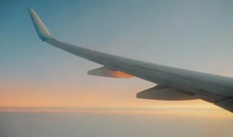 View from window at the sunset and airplane wing