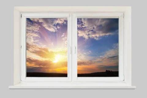 View from the window sunset in cloudy sky over field Stock Photos