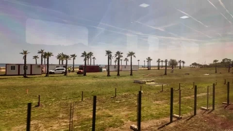 View from the window of the train going to Barcelona, coastline trip in Spain,4K Stock Footage 276448322