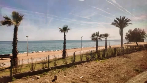 View from the window of the train going to Barcelona, coastline trip in Spain,4K Stock Footage 276448344