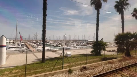 View from the window of the train going to Barcelona, coastline trip in Spain,4k Stock Footage 276448348