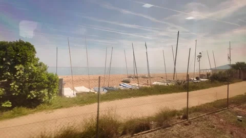 View from the window of the train going to Barcelona, coastline trip in Spain,4K Stock Footage 276448509