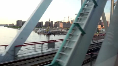 View from the window of a train moving across the river on the railway bridge Stock Footage 133429773