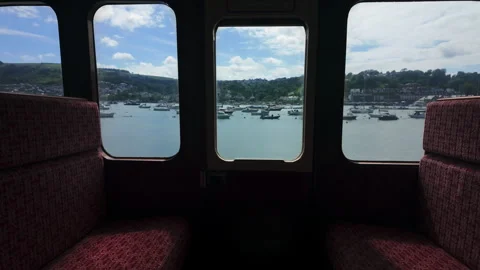 View from the window of a vintage train on a bay with a parking lot for boats Stock Footage 280873326