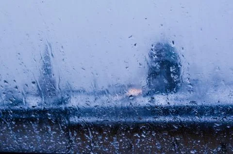 View from the window on a wet winter landscape. Wet snow and white roofs. Stock Photos
